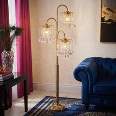 Gold three-light candelabra floor lamp with clear faux crystal shades, featuring an elegant design and a stylish base.