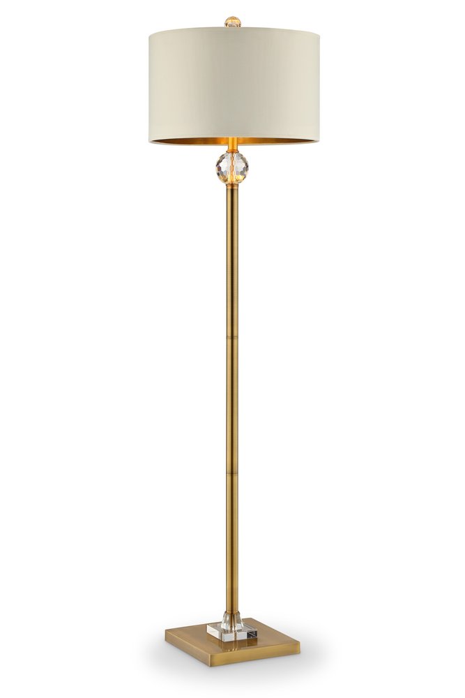 A gold metal column floor lamp topped with an off white metal drum shade.