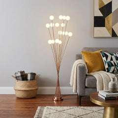 62" Yellow 16 LED Novelty Floor Lamp with White globes, featuring a stylish design in a cozy living room setting.