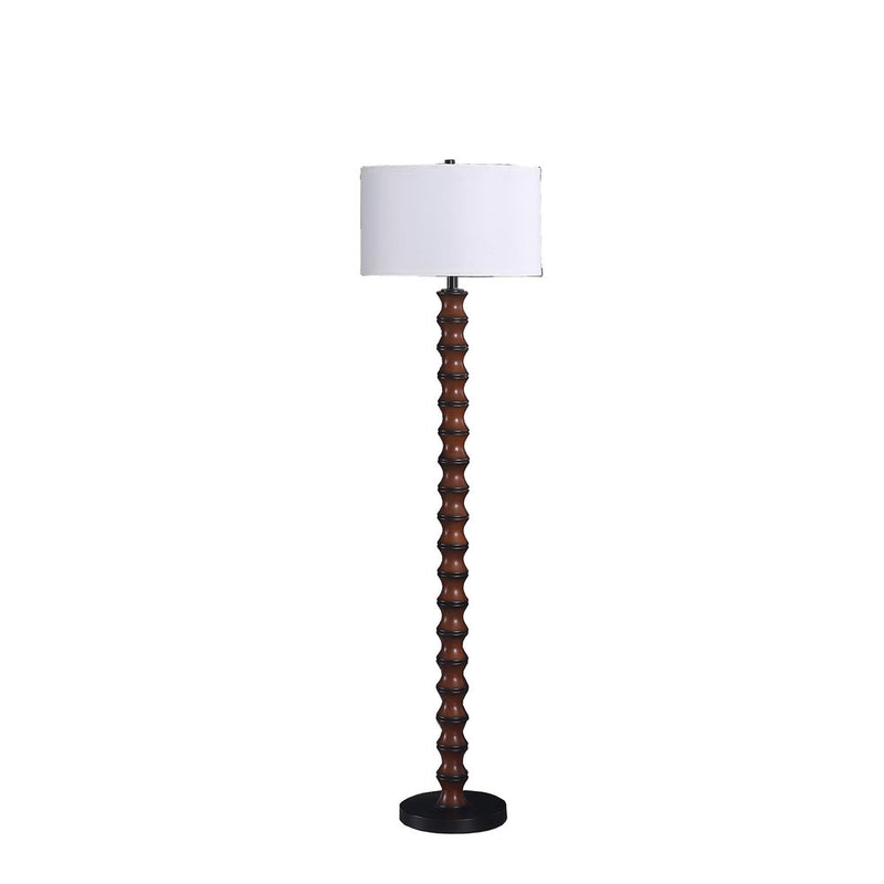 Brown and black floor lamp with a white fabric drum shade.