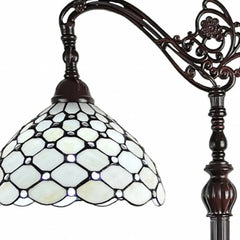62" brown and white metal floor lamp featuring a decorative white glass bowl shade with a honeycomb pattern.