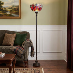 69" black and red torchiere floor lamp featuring a red dragonfly glass dome shade, beside a cozy sofa in a stylish room.