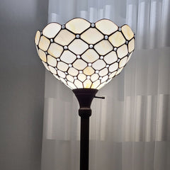 62" brown and white floor lamp featuring a decorative white glass bowl shade with a geometric design. Elegant lighting accent