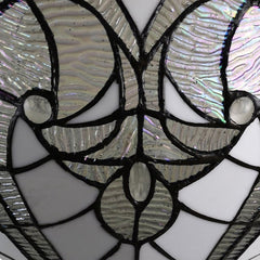 Close-up of the white Tiffany style glass dome shade featuring intricate, iridescent patterns and designs.