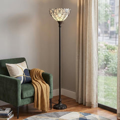 62" Brown Torchiere Floor Lamp with White Tiffany Style Glass Dome Shade, featuring an elegant design beside a green armchair