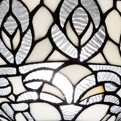 Close-up of the white peacock feather glass dome shade of a 62" brown and white torchiere floor lamp.
