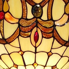 Beige torchiere floor lamp featuring a decorative glass dome shade with red and white flower designs. Elegant and stylish.