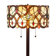 Beige metal torchiere floor lamp with a decorative red and white flowers glass drum shade, featuring two light bulbs.