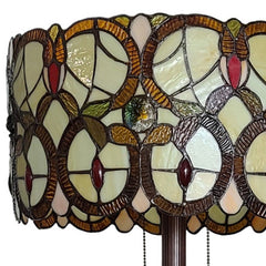 Beige metal torchiere floor lamp with a decorative red and white flowers glass drum shade, featuring intricate stained glass 