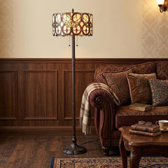 63" beige metal torchiere floor lamp with a red and white flowers glass drum shade, placed next to a cozy sofa.