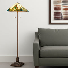 62" Two Light Tiffany Style Floor Lamp featuring an amber, blue, and green stained glass shade beside a gray sofa.