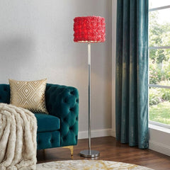 63" steel and acrylic floor lamp with a red flowers fabric drum shade, placed next to a teal couch and a cozy throw.