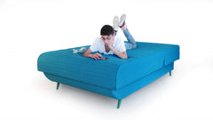 Turquoise full adjustable upholstered polyester mattress without bed frame, featuring a relaxed individual using a smartphone