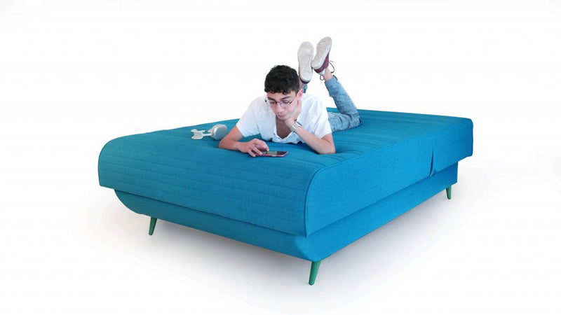 Turquoise full adjustable upholstered polyester mattress without bed frame, featuring a relaxed individual using a smartphone
