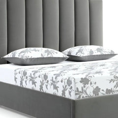 Queen Grey Upholstered Vertical Channel Velvet Bed with USB featuring a plush headboard and floral bedding.
