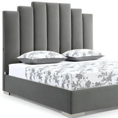 Queen Grey Upholstered Vertical Channel Velvet Bed with USB featuring a tall, channel-stitched headboard and floral bedding.
