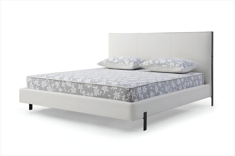 White wood and faux leather king bed frame with USB, featuring a sleek design and two pillows on a patterned mattress.