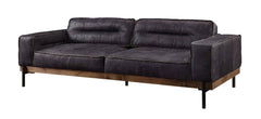 96" Ebony Top Grain Leather Sofa with black legs, featuring a modern design and plush cushions for comfort.