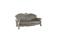 96" Bone Faux Leather Sofa with tufted design, decorative white legs, and included toss pillows for added comfort.
