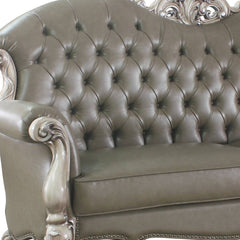 96" Bone Faux Leather Sofa with tufted design, decorative white legs, and included toss pillows for added comfort.