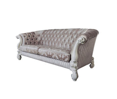 Ivory velvet damask sofa with tufted back, decorative bone legs, and matching toss pillows. Elegant and luxurious design.