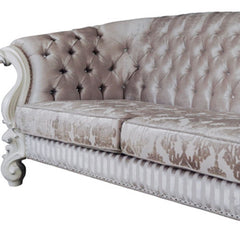 Ivory velvet damask sofa with tufted design, bone legs, and matching toss pillows, showcasing elegant detailing.