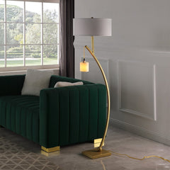 59" Gold and White Arc Floor Lamp with White Fabric Drum Shade, featuring a sleek design and a stylish green couch in the bac