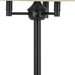 Bronze four light floor lamp with a beige fabric square shade, showcasing the lamp's base and light fixture details.