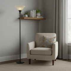 71" Bronze Torchiere Floor Lamp with beige frosted glass dome shade beside a cozy armchair and shelf with plants and books.