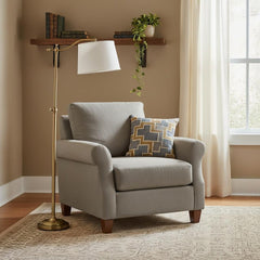 63" Bronze Adjustable Height Swing Arm Floor Lamp with White Fabric Shade beside a gray armchair and decorative pillow in a c