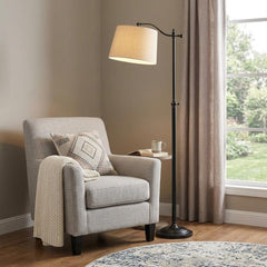 63" Bronze Metal Adjustable Floor Lamp with Tan Paper Square Shade beside a cozy armchair, enhancing a warm living space.