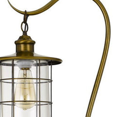 Brass traditional floor lamp with a bronze transparent glass drum shade, showcasing an elegant design and warm lighting.