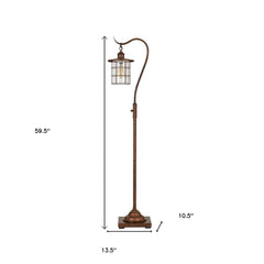 60" rusted traditional floor lamp with a rust transparent glass drum shade and curved arm, featuring a square base.