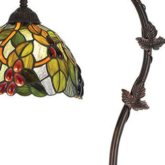 61" bronze floor lamp featuring a green and yellow glass dome shade with intricate leaf and berry designs.