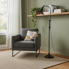58" Bronze Metal Adjustable Floor Lamp with a dome shade, paired with a cozy gray armchair and a light-colored rug in a styli