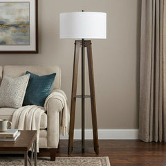 65" Brown Tripod Floor Lamp with White Rectangular Shade, featuring a wooden base and a modern design, placed beside a cozy s