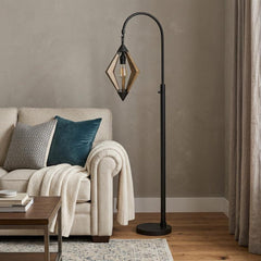 67" Black Traditional Shaped Floor Lamp with a diamond-shaped wooden shade, placed next to a cozy sofa and throw blanket.