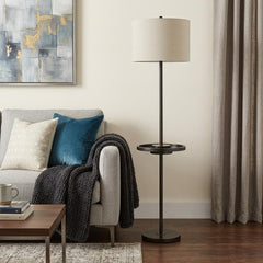62" Bronze Tray Table Floor Lamp with Beige Drum Shade, featuring a modern design beside a cozy sofa and decorative pillows.