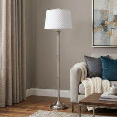 60" Nickel Traditional Floor Lamp with a textured white square shade, standing beside a cozy sofa in a stylish living room.