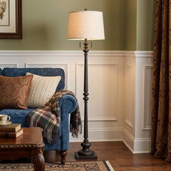 63" rust two-light floor lamp with a beige fabric square shade, positioned next to a blue couch with decorative pillows and a