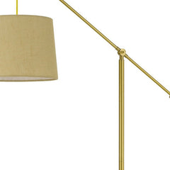 68" Brass Adjustable Traditional Floor Lamp with an antiqued brass drum shade, featuring a sleek design and adjustable arm.
