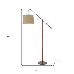 68" adjustable floor lamp with a rusted finish and drum shade, featuring a traditional design and sturdy base.