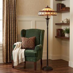 61" Bronze Two Light Traditional Floor Lamp featuring a Purple and Ivory Abstract Tiffany Glass Empire Shade, beside a green 
