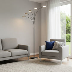 82" Bronze Five Light LED Arc Floor Lamp with curved arms, illuminating a cozy living room with gray furniture and a soft rug