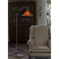 65" rusted traditional floor lamp with a rust empire shade, featuring a curved arm and a sturdy base, set in a cozy living ro