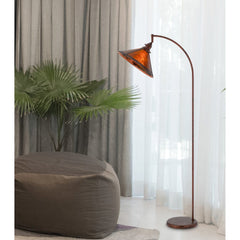 65" rusted traditional floor lamp with rust empire shade, featuring a curved design and placed near a plant and bean bag.