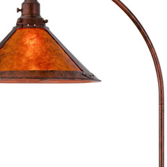 65" rusted traditional floor lamp featuring a rust empire shade with a warm, amber glow. Ideal for vintage decor.