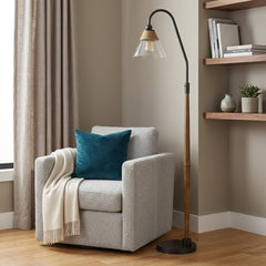 71" brown traditional floor lamp with clear glass empire shade, beside a cozy armchair and decorative shelf.
