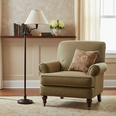59" Bronze Swing Arm Floor Lamp with Beige Empire Shade next to a green armchair with a decorative pillow in a cozy room sett