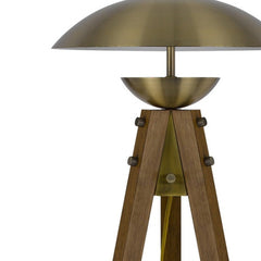 55" Brass Tripod Floor Lamp features an antiqued brass dome shade and a stylish wooden tripod base. Elegant and modern design